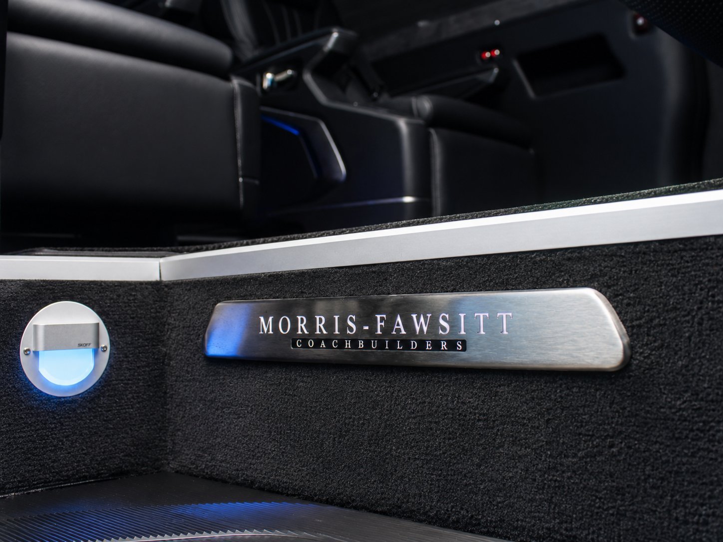 Morris-Fawsitt Coachbuilders nameplate on luxury car interior trim with blue lighting detail