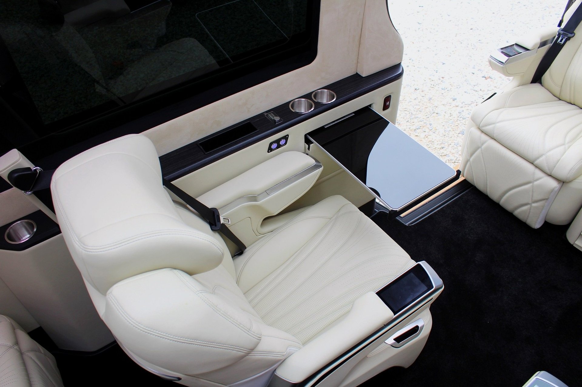 Overhead view of luxury boat cabin interior with white leather seating and storage compartments