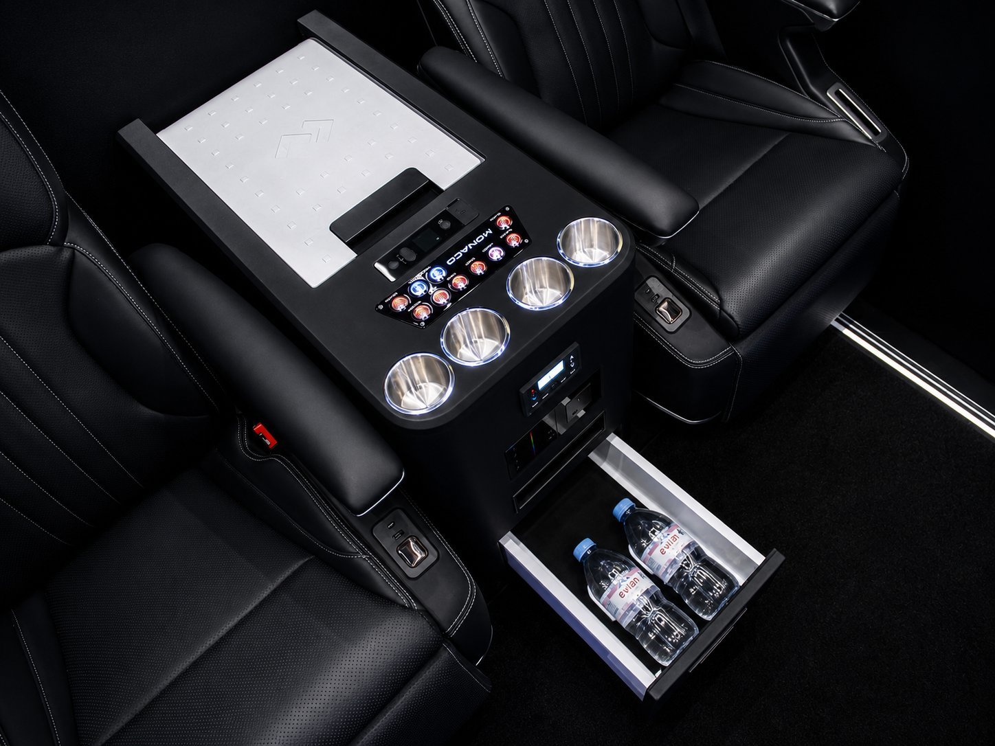 Custom car interior console with four recessed LED lights, control panel with buttons, and open storage drawer containing beverage cans