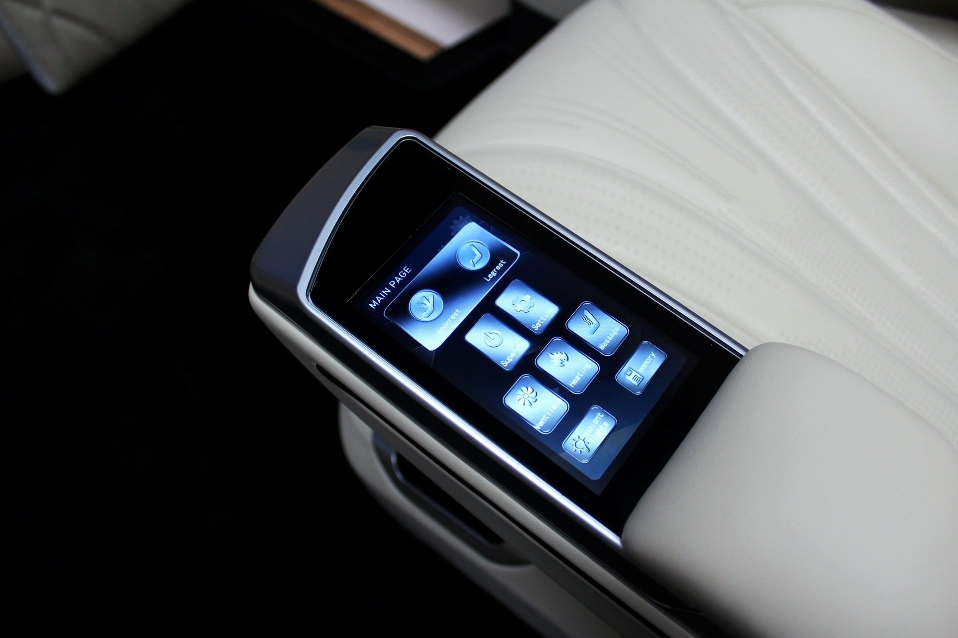 Smartwatch with rectangular touchscreen displaying app icons, placed on white wrist band against black background