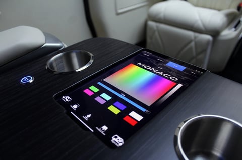 Korg Kaoss Pad music production controller with colorful touchscreen interface and control buttons displayed on a car armrest