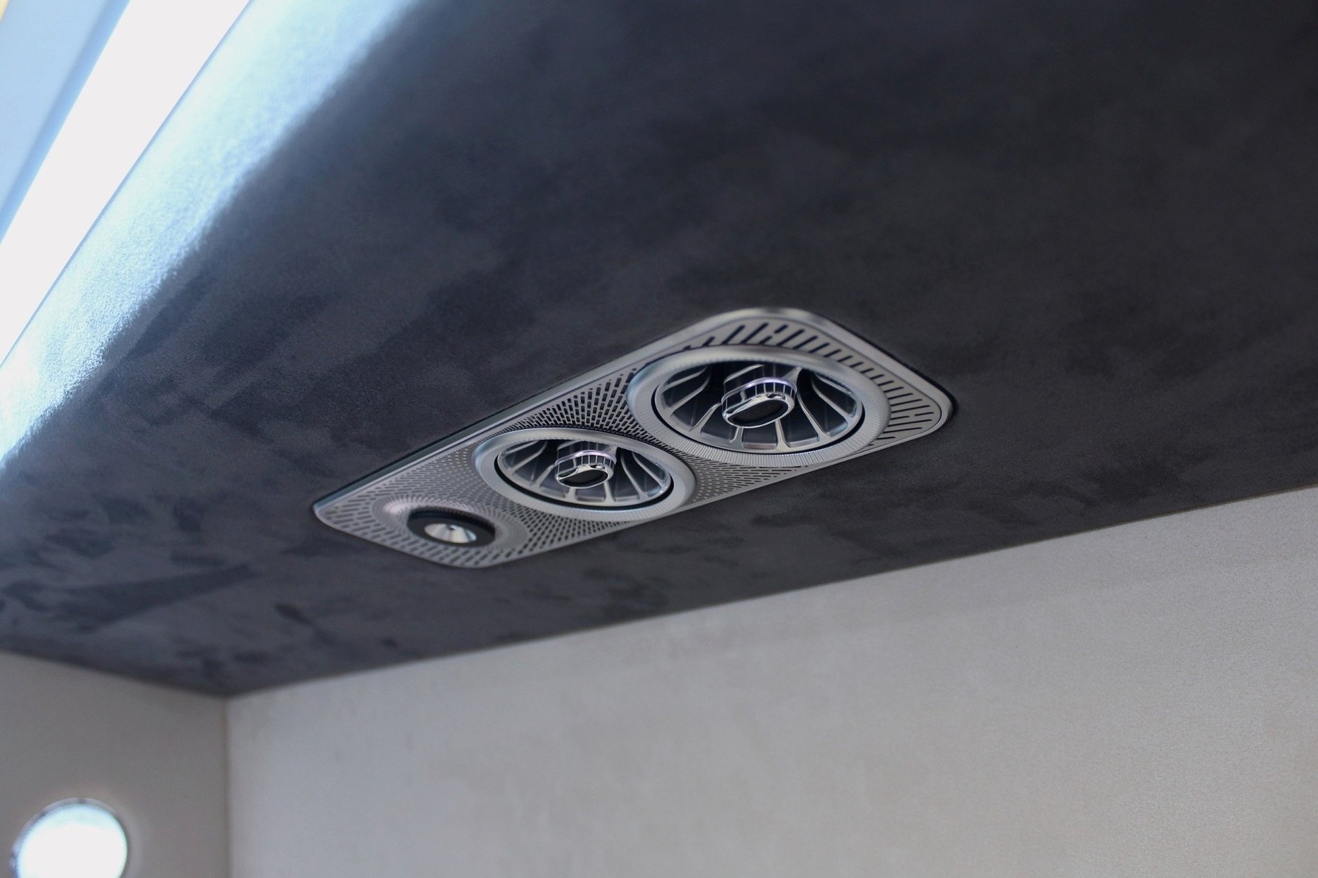 Ceiling-mounted dual exhaust or ventilation fans with oval grilles installed in a dark recessed panel above white walls