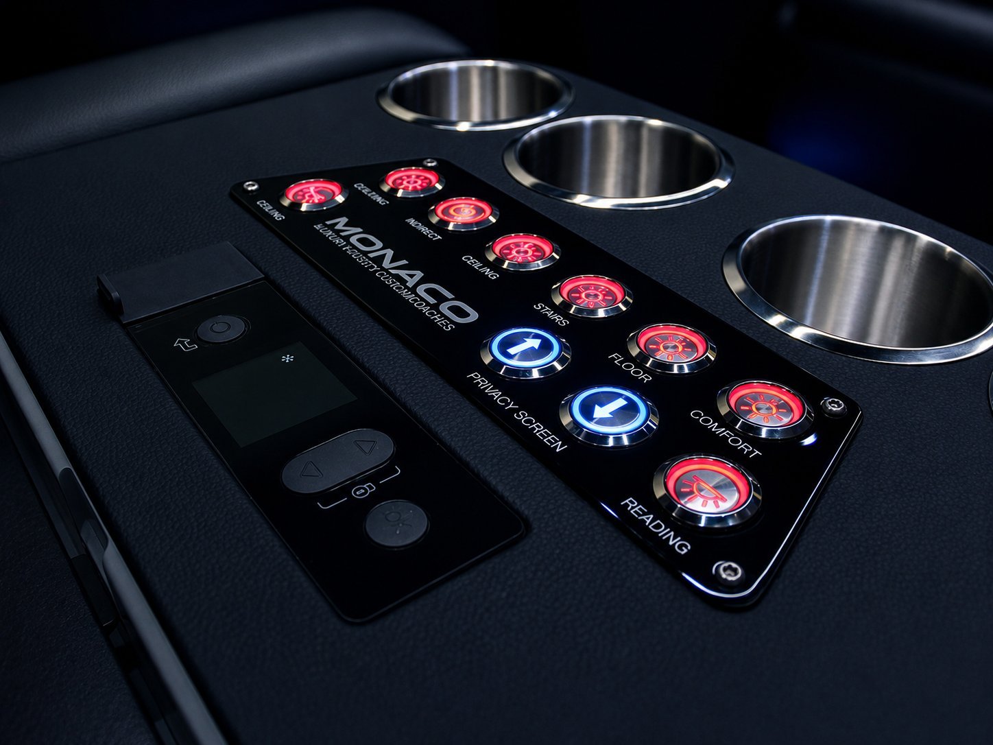 Close-up of a black DJ mixer control panel with red and blue illuminated buttons, stainless steel cups, and knobs against a dark surface